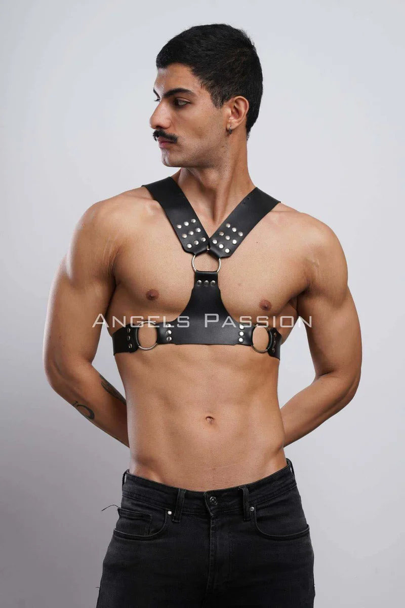 Black faux leather chest harness with silver studs and O-ring detail