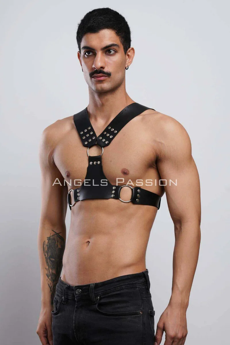 Black studded faux leather chest harness with O-rings on model