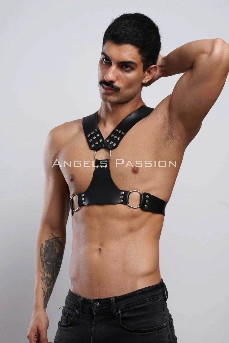 Black faux leather chest harness with o-rings and studs showing front straps