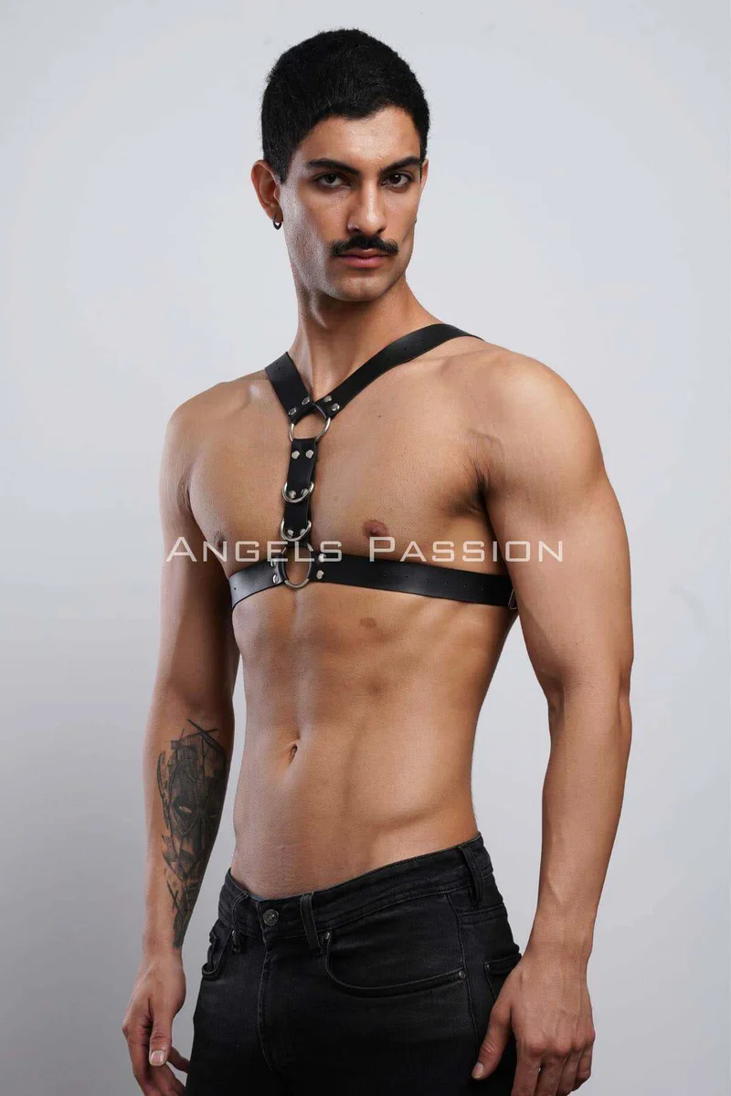 Side view of black faux leather chest harness with O-ring detail