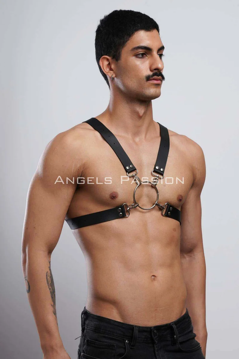 Black chest harness flat lay showcasing the O-ring and strap design