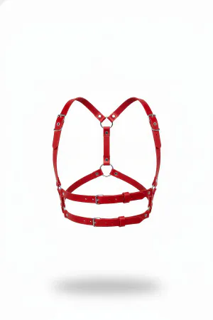Red Faux Leather Chest Harness with O-Ring Detail, adjustable buckle straps in a minimalist style, against a white background