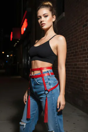 Red Faux Leather Waist Harness with Tassels and O-Rings, worn over jeans
