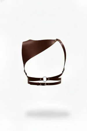 Asymmetrical faux leather body harness in rich brown, featuring a wide shoulder panel and silver O-ring waist detail