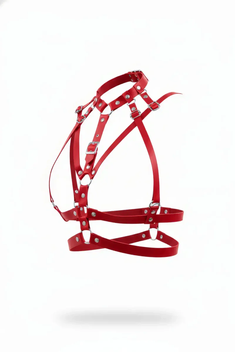 Red faux leather multi-strap chest harness with silver hardware, side view.