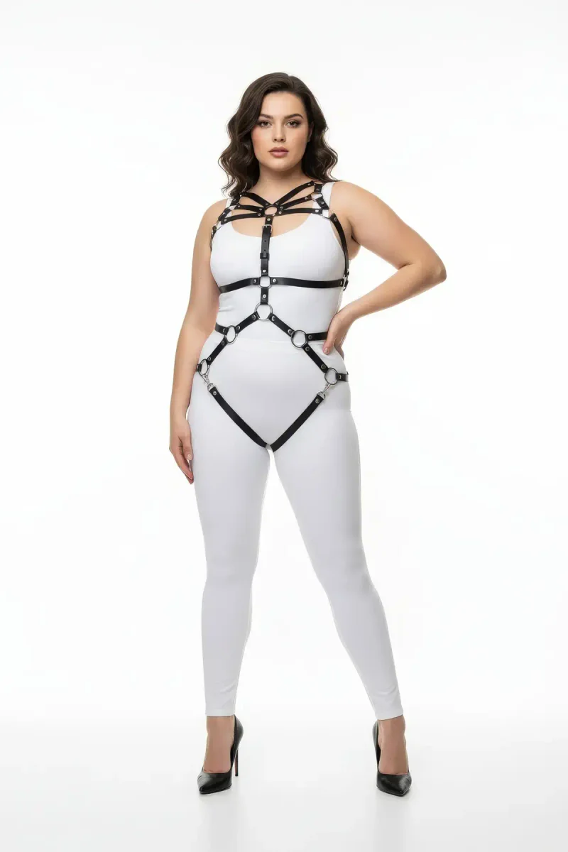 Black faux leather full body harness with O-ring details and adjustable straps on a plus-size model.