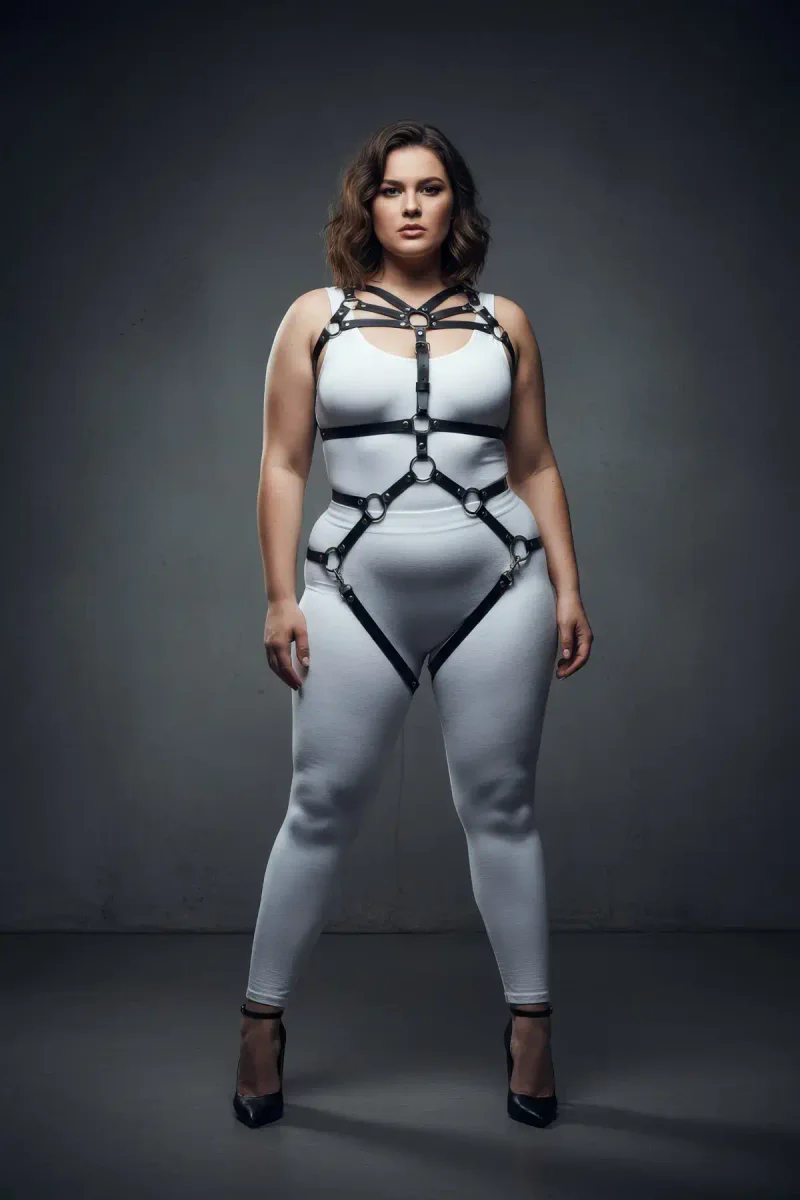 Full body harness black faux leather lingerie with metal O-ring details worn by model