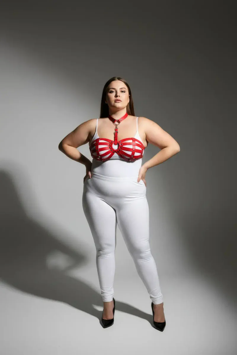 Red faux leather chest harness front view with O-ring detail