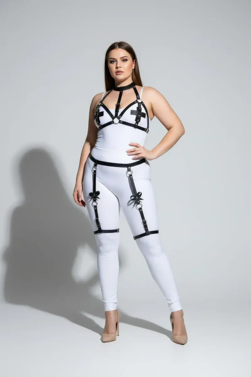 Black strappy garter body harness with O-ring accents on white outfit